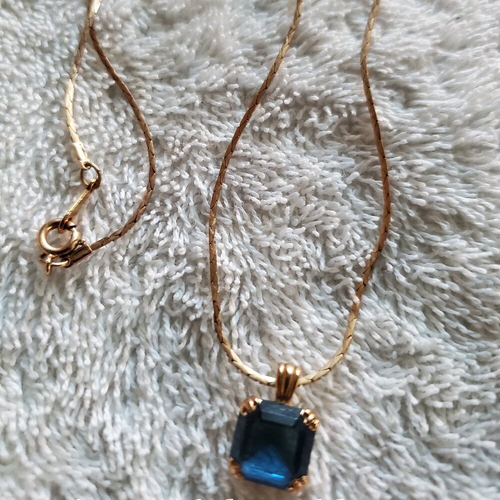 A beautiful necklace gold chain with a blue stone , Item A-28, treat yourself